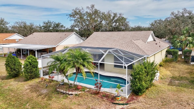 rear view of property with a lanai and a patio area