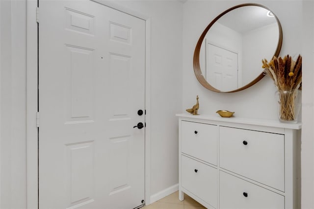 entryway featuring light tile patterned flooring and baseboards