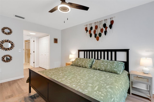 bedroom with visible vents, a closet, light wood-style floors, baseboards, and ceiling fan