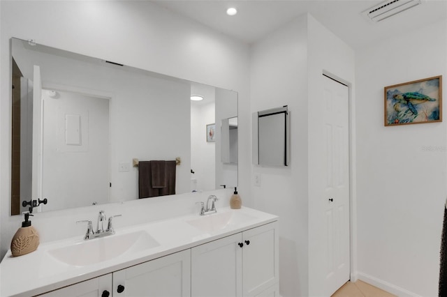 full bath featuring double vanity, visible vents, tile patterned floors, and a sink