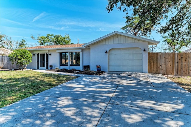 ranch-style home featuring a garage and a front yard