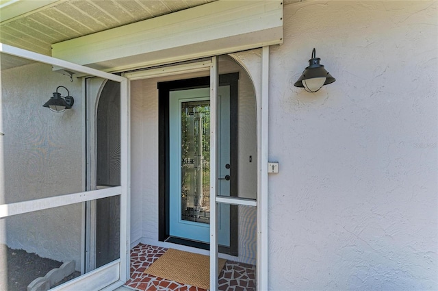 property entrance with stucco siding