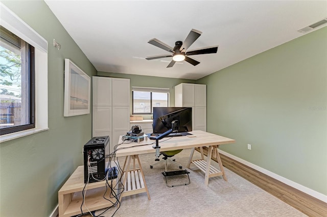 office featuring visible vents, baseboards, and wood finished floors