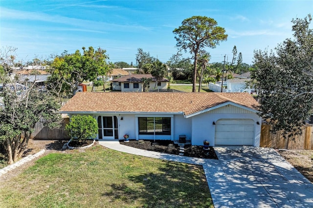 single story home with an attached garage, fence, driveway, stucco siding, and a front lawn