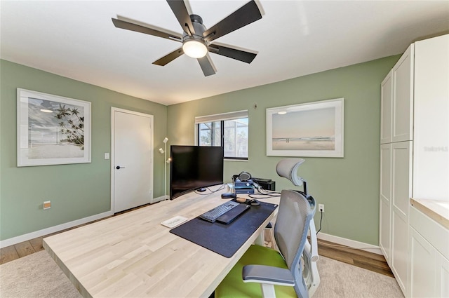 office with light wood-style floors, baseboards, and a ceiling fan