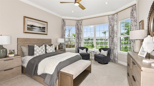 carpeted bedroom featuring ornamental molding and ceiling fan