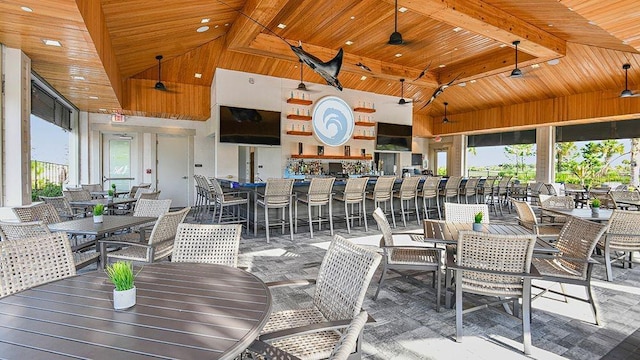 dining space featuring high vaulted ceiling, a healthy amount of sunlight, and wood ceiling