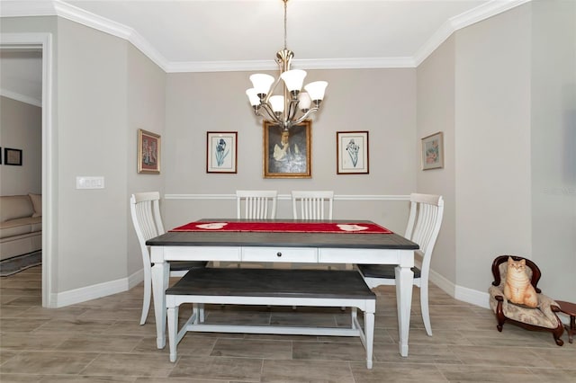 dining space with ornamental molding and a notable chandelier