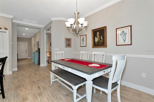dining area with ornamental molding and a notable chandelier