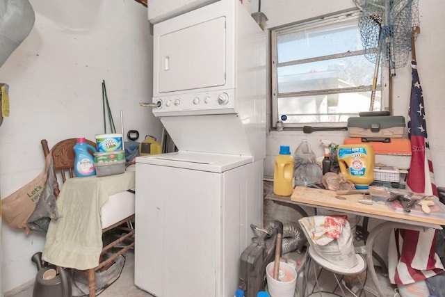 laundry room with stacked washer / drying machine and laundry area