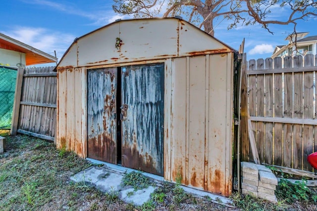 view of shed featuring fence