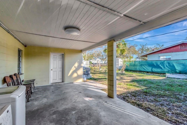 view of patio / terrace with washer / dryer and fence