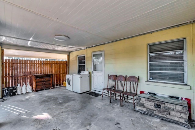 view of patio / terrace featuring fence and separate washer and dryer