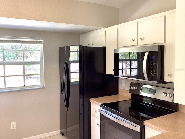 kitchen with white cabinetry, stainless steel range with electric stovetop, and black fridge with ice dispenser