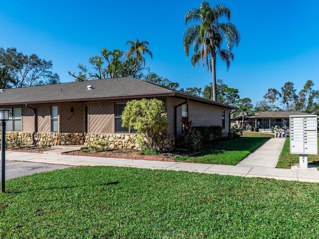 ranch-style home featuring a front yard