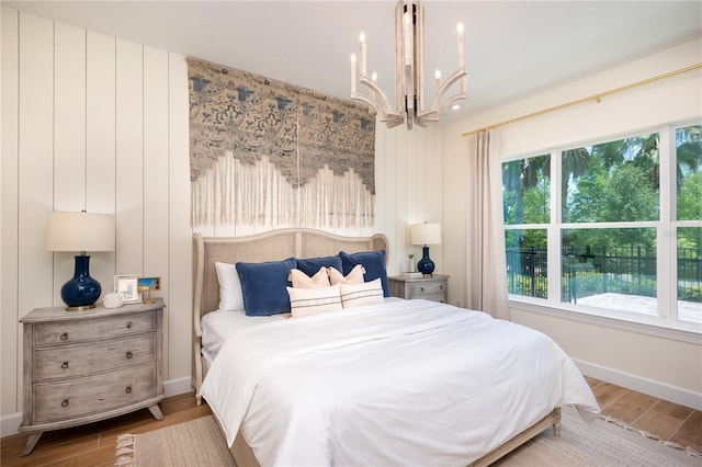 bedroom featuring hardwood / wood-style floors and a notable chandelier