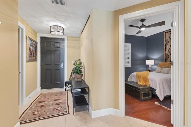 tiled entrance foyer featuring ceiling fan