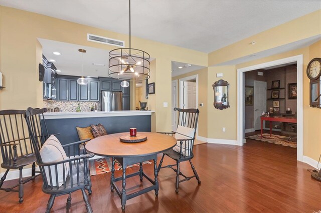 dining space with dark hardwood / wood-style flooring