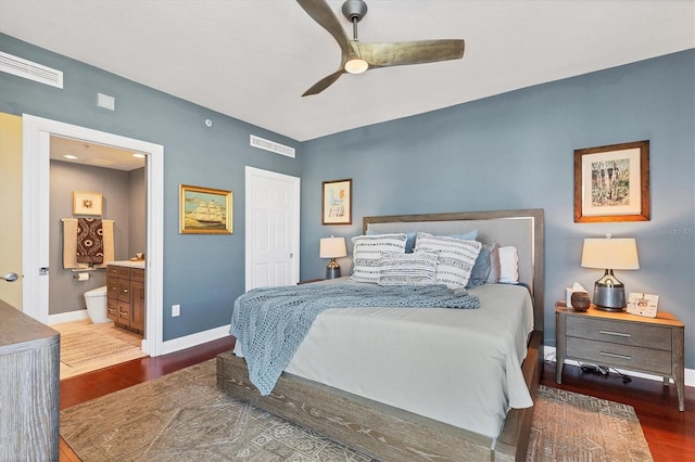 bedroom with ceiling fan, connected bathroom, and dark hardwood / wood-style floors