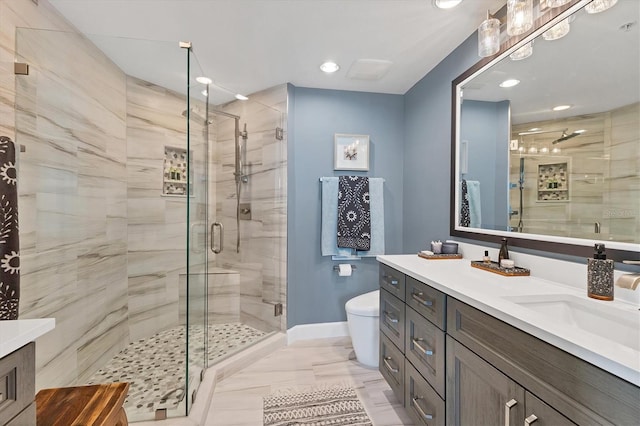 bathroom with walk in shower, vanity, and toilet