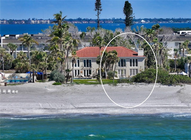 aerial view with a view of the beach, a water view, and a view of city