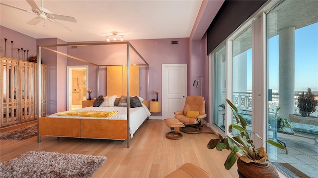 bedroom featuring access to exterior and light wood-type flooring