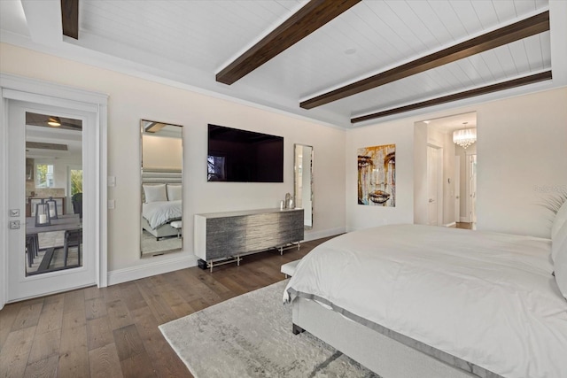 bedroom with an inviting chandelier, dark wood-type flooring, and beam ceiling