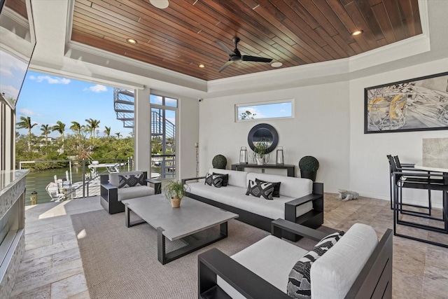 interior space featuring ornamental molding, wooden ceiling, ceiling fan, and a raised ceiling