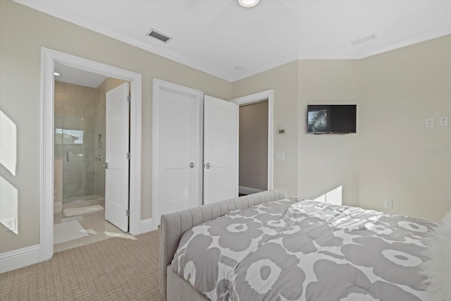 carpeted bedroom with crown molding and ensuite bathroom