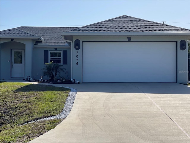 single story home with a garage and a front yard