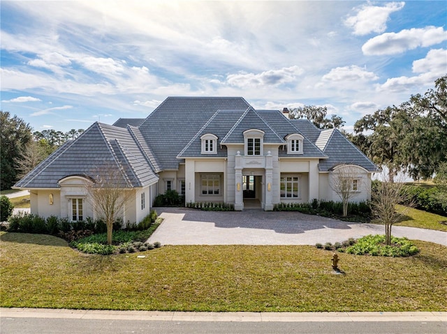 french provincial home featuring a front yard