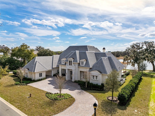 french country home with a front lawn