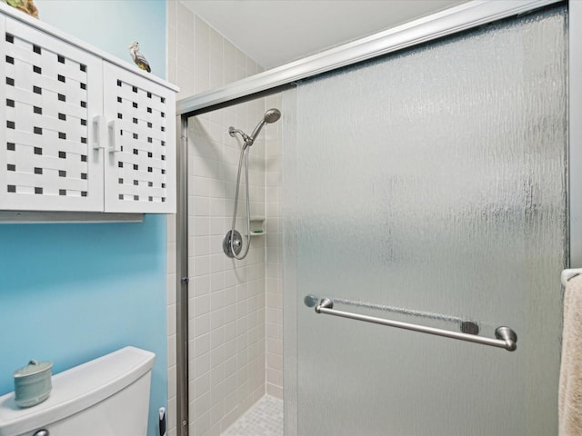 bathroom featuring an enclosed shower and toilet