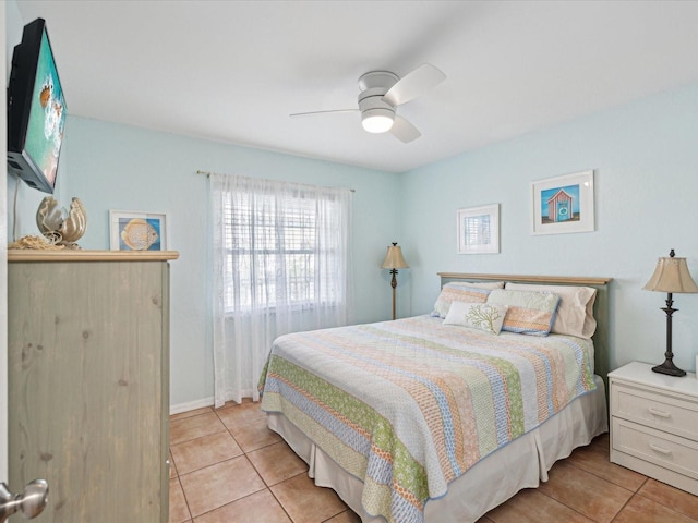 bedroom featuring light tile patterned floors, ceiling fan, and baseboards