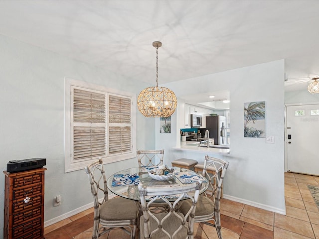 dining space with light tile patterned floors and baseboards