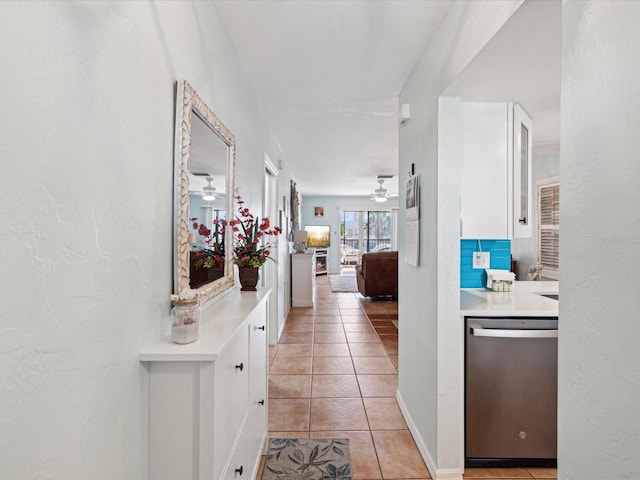 hall with baseboards and light tile patterned flooring