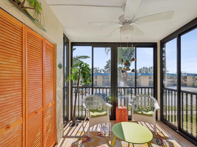 sunroom featuring a wealth of natural light and a ceiling fan