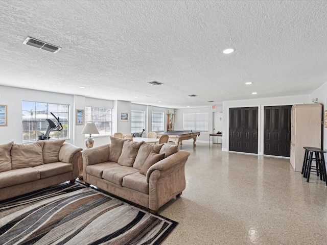 living room with a textured ceiling, pool table, speckled floor, and visible vents