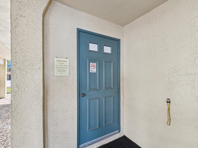 doorway to property with stucco siding