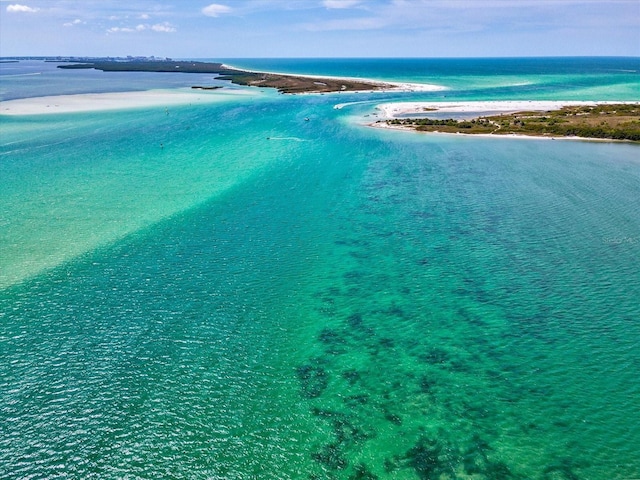 drone / aerial view featuring a water view and a view of the beach