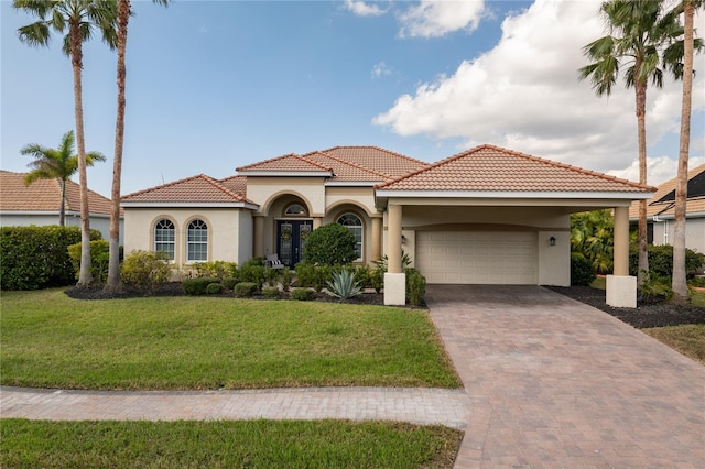 mediterranean / spanish home with a garage and a front yard