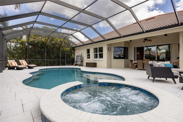 view of swimming pool featuring outdoor lounge area, an in ground hot tub, ceiling fan, glass enclosure, and a patio area