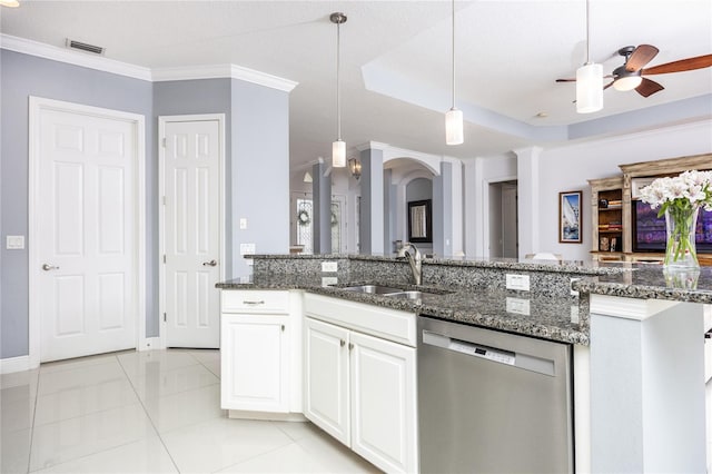 kitchen featuring sink, hanging light fixtures, dark stone countertops, dishwasher, and white cabinets