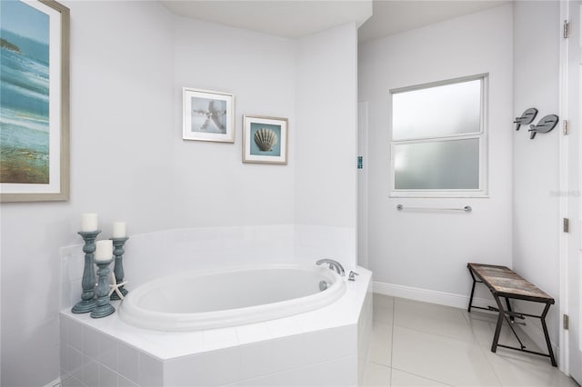 bathroom with tile patterned flooring and tiled tub