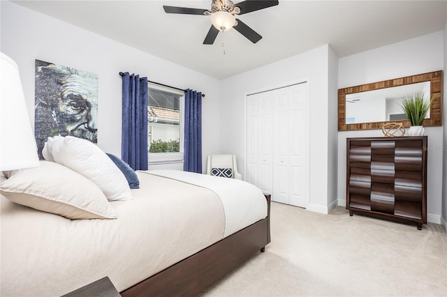 bedroom with light colored carpet, a closet, and ceiling fan