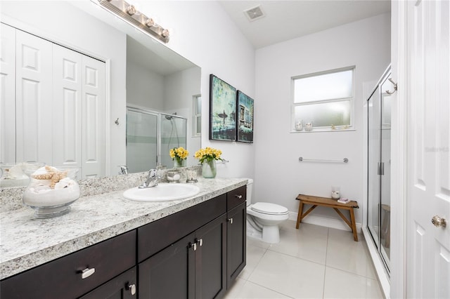 bathroom with vanity, toilet, an enclosed shower, and tile patterned flooring