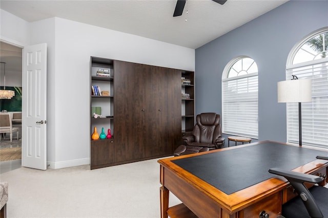 office area with ceiling fan, light carpet, and a textured ceiling