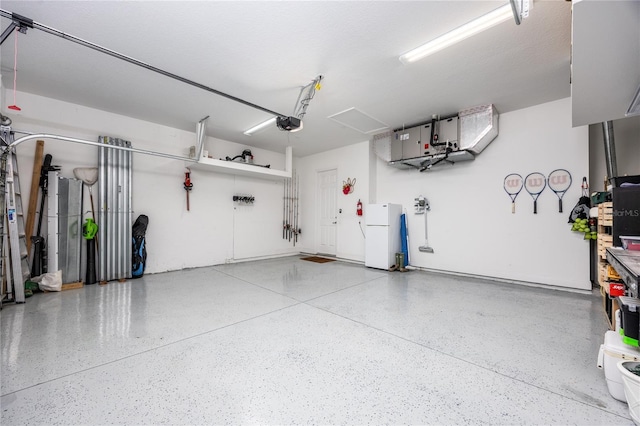 garage featuring a garage door opener and white fridge