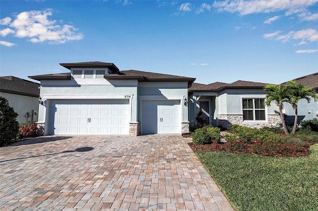 prairie-style home featuring a garage and a front yard