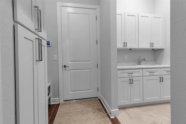 interior space featuring sink and light hardwood / wood-style flooring